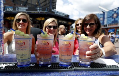 Fans show off their Honey Deuce cocktails at the 2016 U.S. Open tennis tournament.