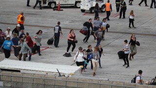 Passengers run on tarmac