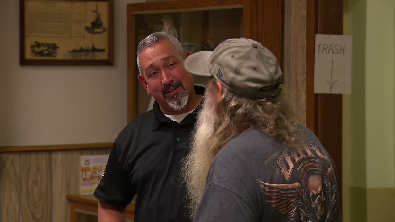 Jim Adams, left, of IBEW Local 129 talks to one of the people attending a community open house about a proposed data center in Monroeville.