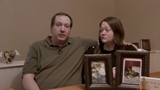 The Zylk Family with a photo of their dog.