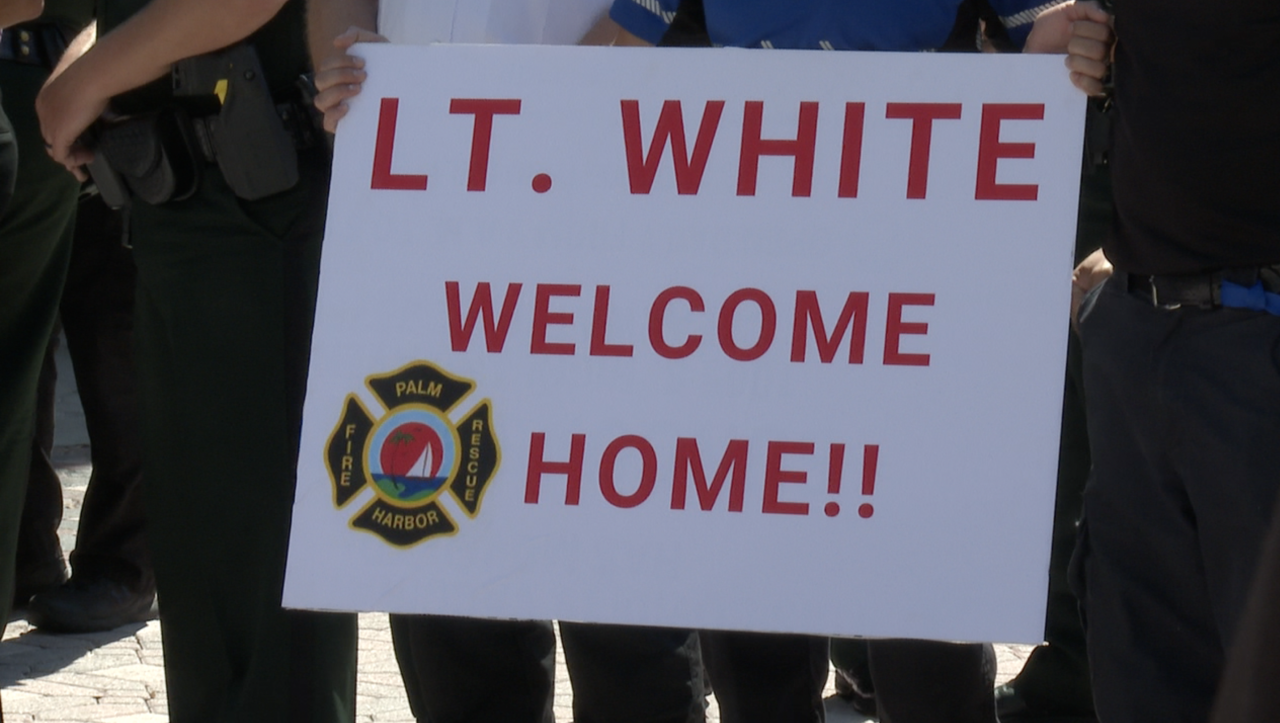Lt. Ashley White is welcomed home after being treated for injuries suffered in a crash