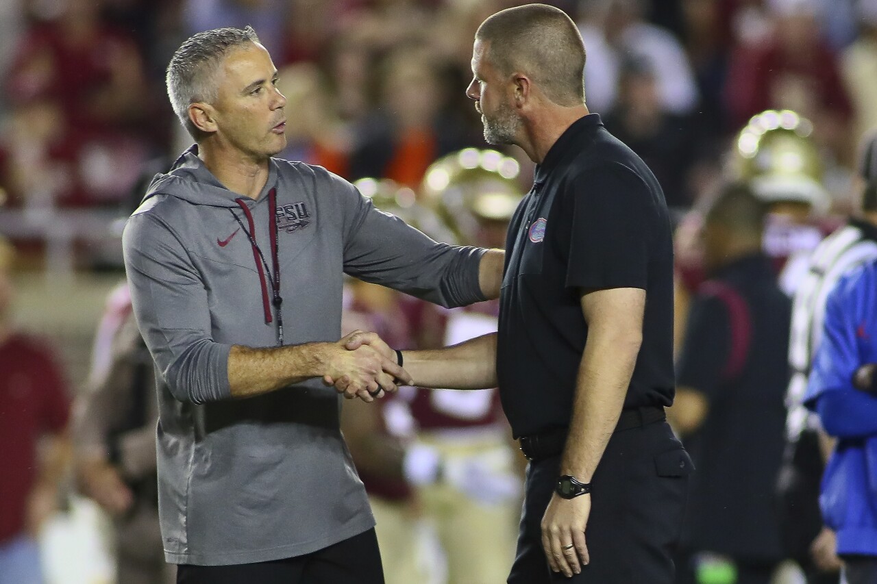 Florida State Seminoles head coach Mike Norvell shakes hands with Florida Gators head coach Billy Napier before game, Nov. 25, 2022