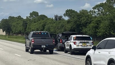 A black SUV was pulled over and a suspect was taken into custody believed to be connected to a shooting incident at Trump International in Palm Beach County. 