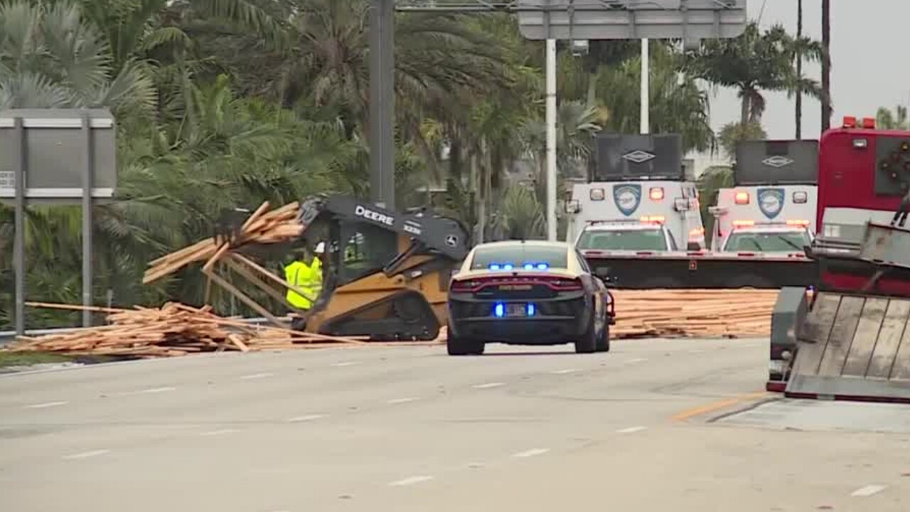 Crews remove pallets of spilled lumber off Interstate 95 in Jupiter on Jan. 12, 2022.jpg