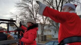 Santa Claus and helpers deliver gifts to Great Falls children