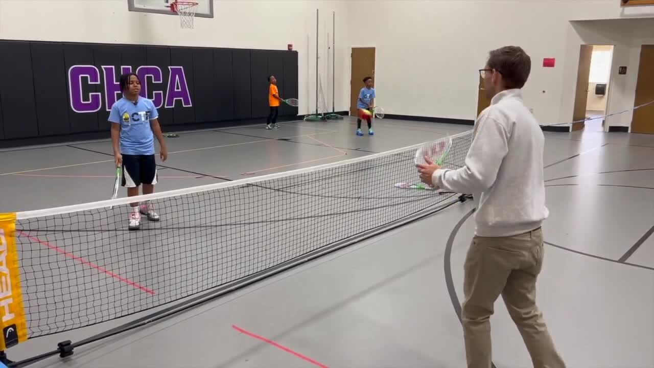 Cam plays tennis with the youth