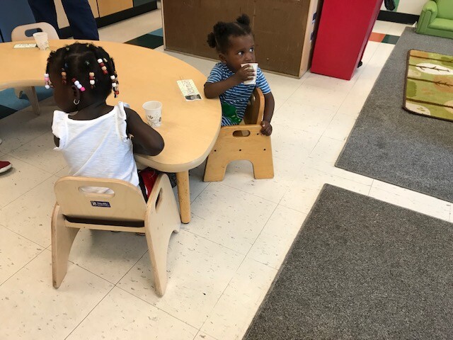 Two female students sitting at a table at a Milwaukee daycare