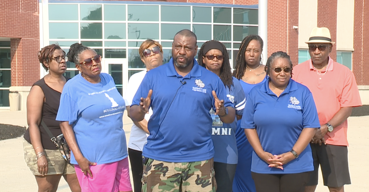 Woodward Alumnal Association President Eddie Hawkins speaks at a news conference with group members on July 25