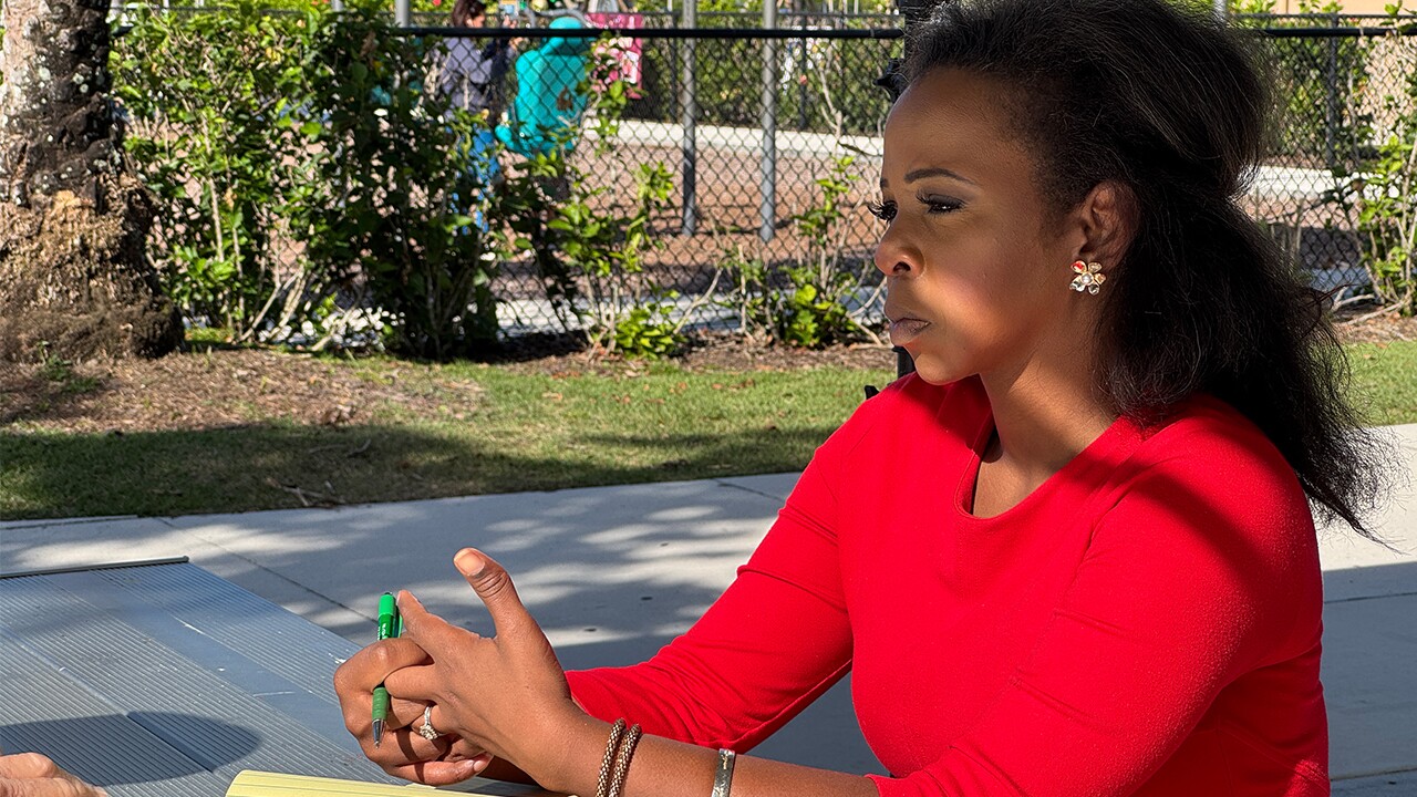 WPTV News anchor Hollani Davis speaks to a resident at North County District Park in Palm Beach Gardens on Dec. 5, 2024.jpg