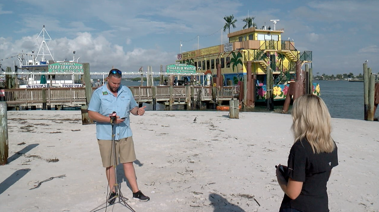 Dylan Hubbard, Owner of Hubbard's Marina, stand on sand buildup, where there once was several feet of water