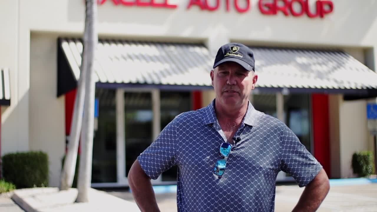 Frederick Hall stands outside Excell Auto Group, wondering what happened to his Lamborghini