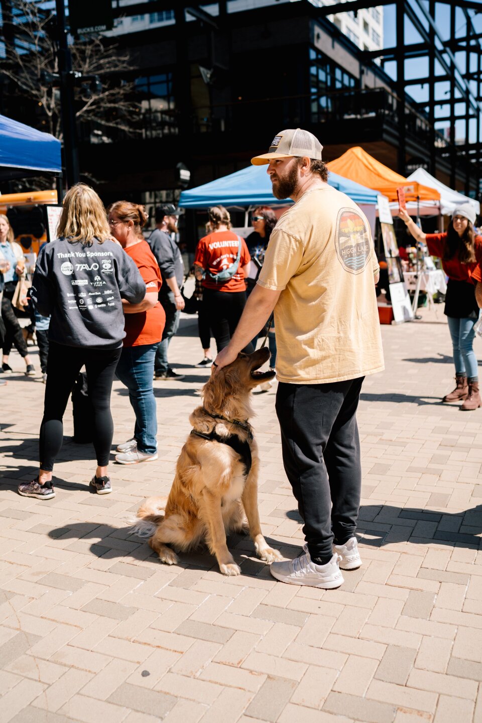 Busy - Guy and pup in middle of people.jpg