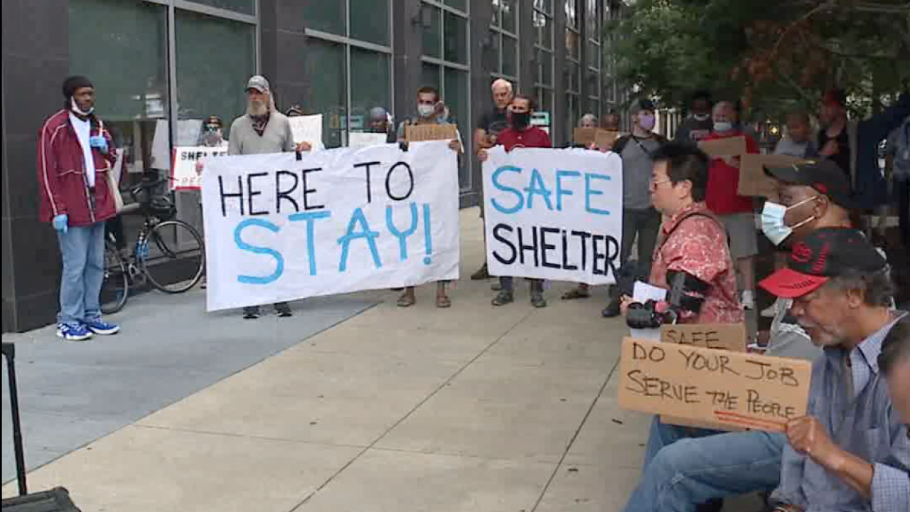 Homeless men living at Ramada Inn gather outside county headquarters