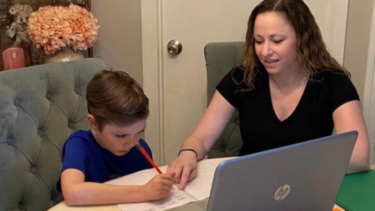 Palm Beach County mother Leah McIntyre helps her son, Ryan, with distance learning during the 2020-21 school year.jpg
