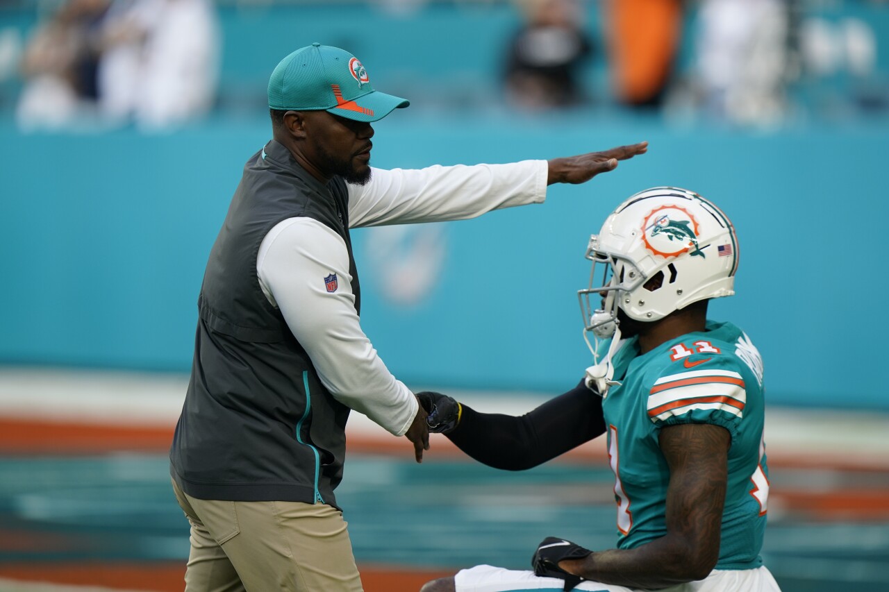 Miami Dolphins head coach Brian Flores works with receiver DeVante Parker during warm-ups before game vs. New England Patriots, Jan. 9, 2022
