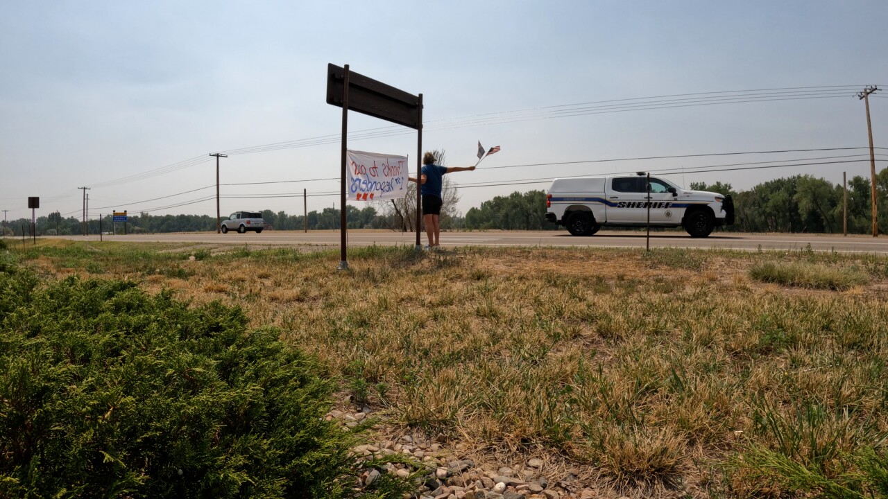 car drives past sign .jpg