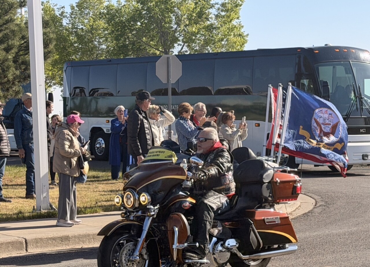 Community members cheer on the veterans as they head to the airport. 
