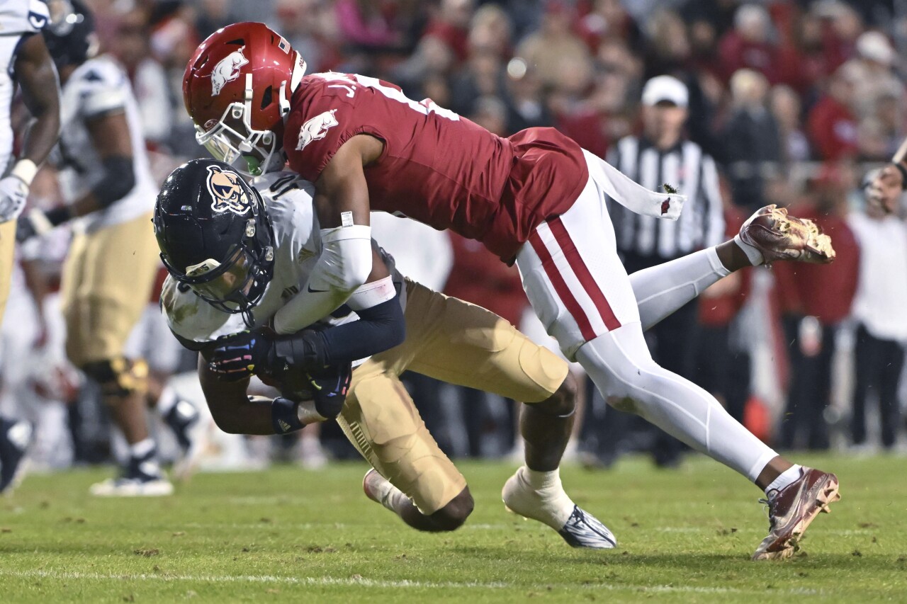 FIU Panthers receiver Kris Mitchell tackled by Arkansas Razorbacks safety Jayden Johnson in second half, Nov. 18, 2023