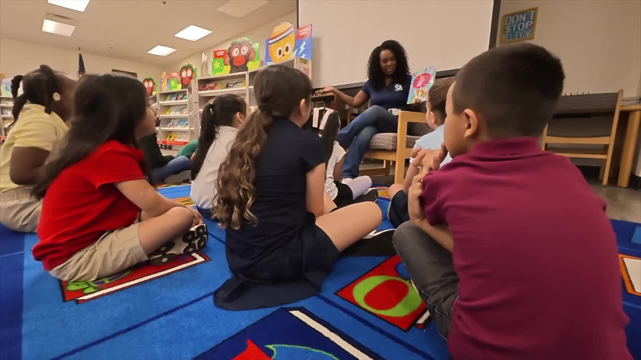 Vannia Joseph give a child a book initiative Fort Pierce Weatherbee Elementary.jpg