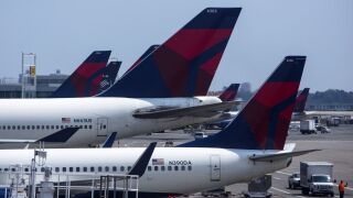 Delta Airlines planes sit at a Terminal at John F. Kennedy Airport.
