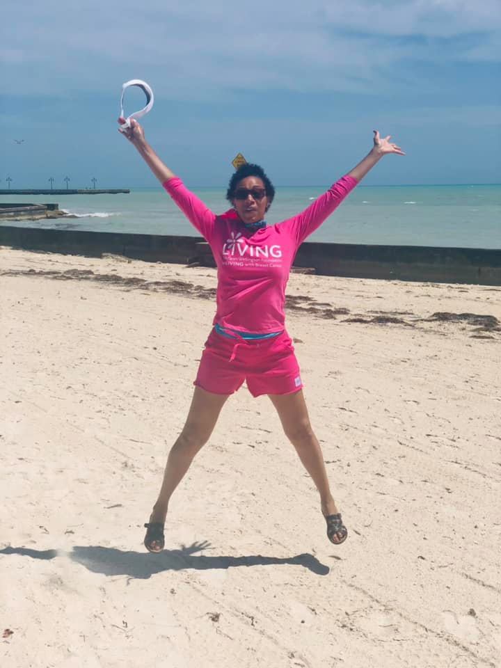 Sherry Hughes in a photo taken in April 2021 during a trip with her husband. The photo shows her jumping in the air as she's wearing a pink long-sleeved shirt and pink shorts.