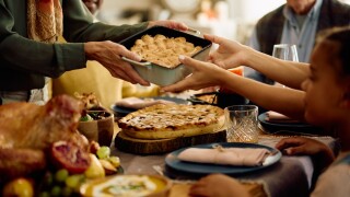 Close,Up,Of,Senior,Woman,Serving,Food,To,Her,Family