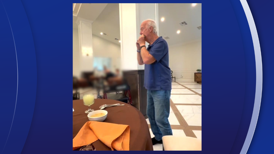 Gene Ray plays his harmonica at The Waverly for staff and other residents