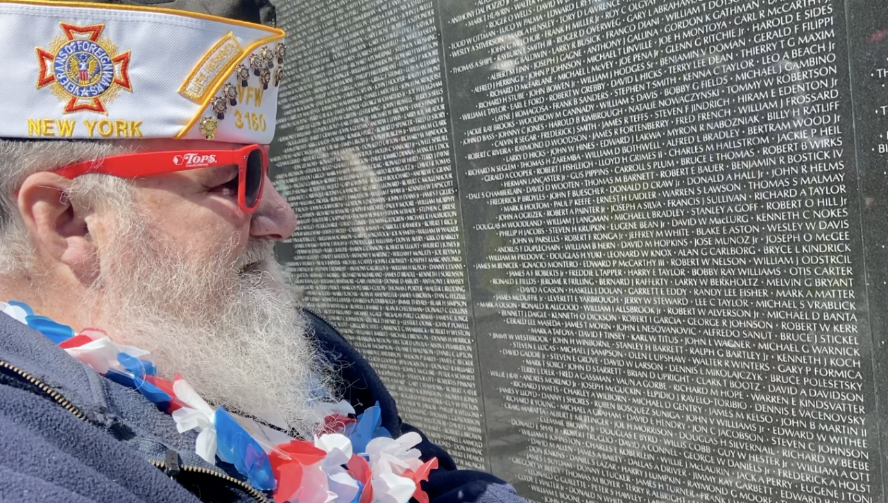 Ayler searches for his friend's name on the Vietnam Memorial wall