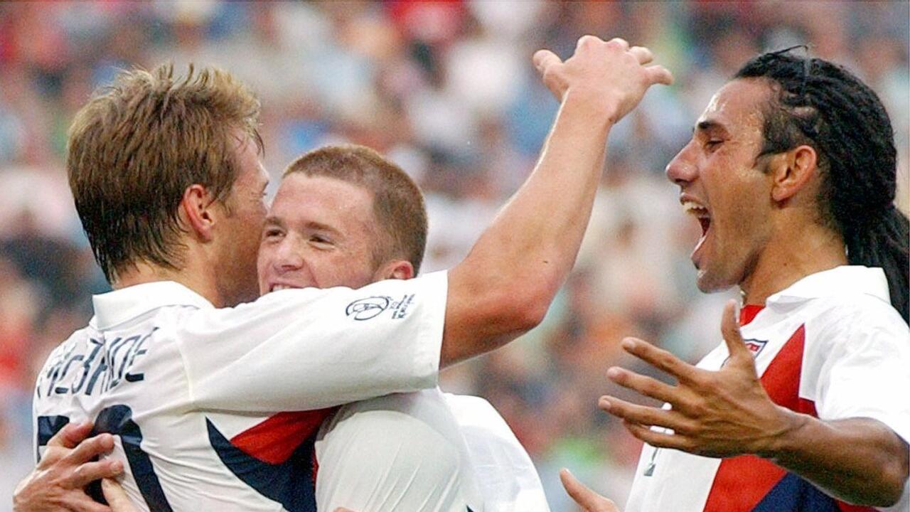 Brian McBride, John O'Brien, and Pablo Mastroeni (l-r), as 2002 USA World Cup Soccer players, celebrate scoring against Portugal, photo