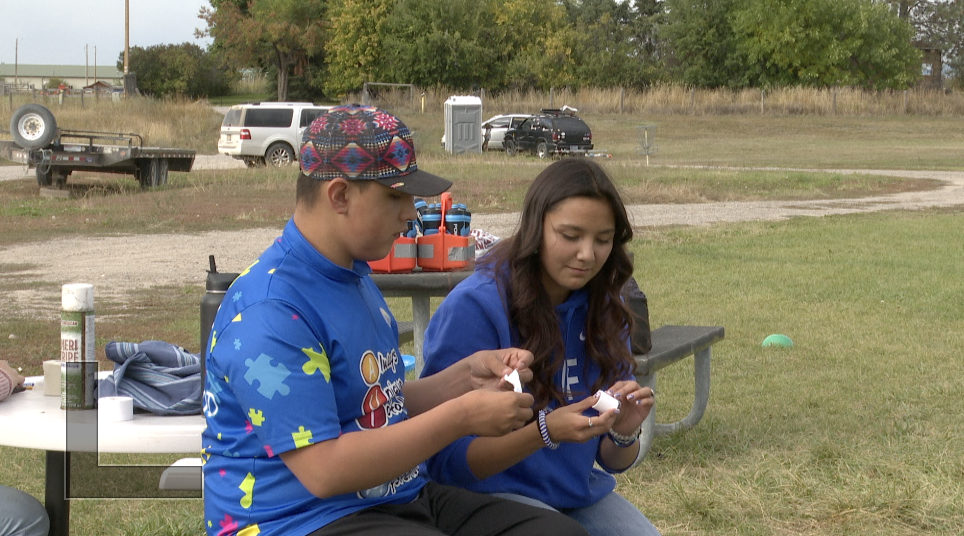 Immanuel Olson and his cousin Jordann Underwood wrapping up athletic tape, St. Igntatius Mt.