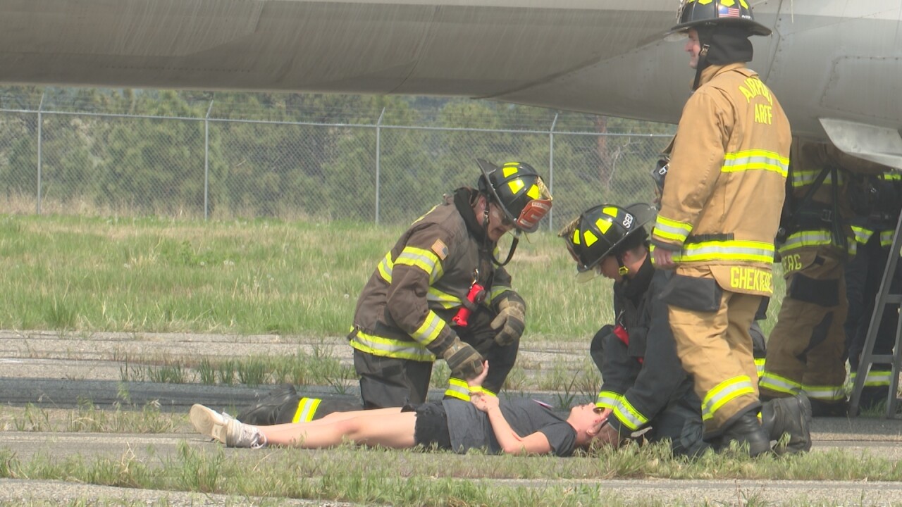Firefighter holds the hand of a "victim"