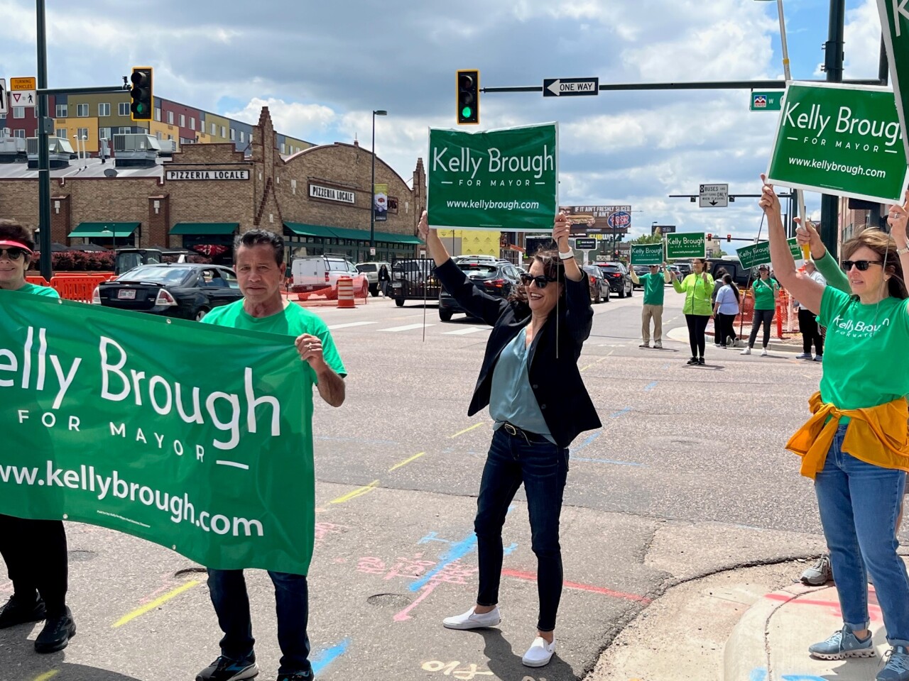 Kelly Brough and supporters at 6th and Broadway Monday.