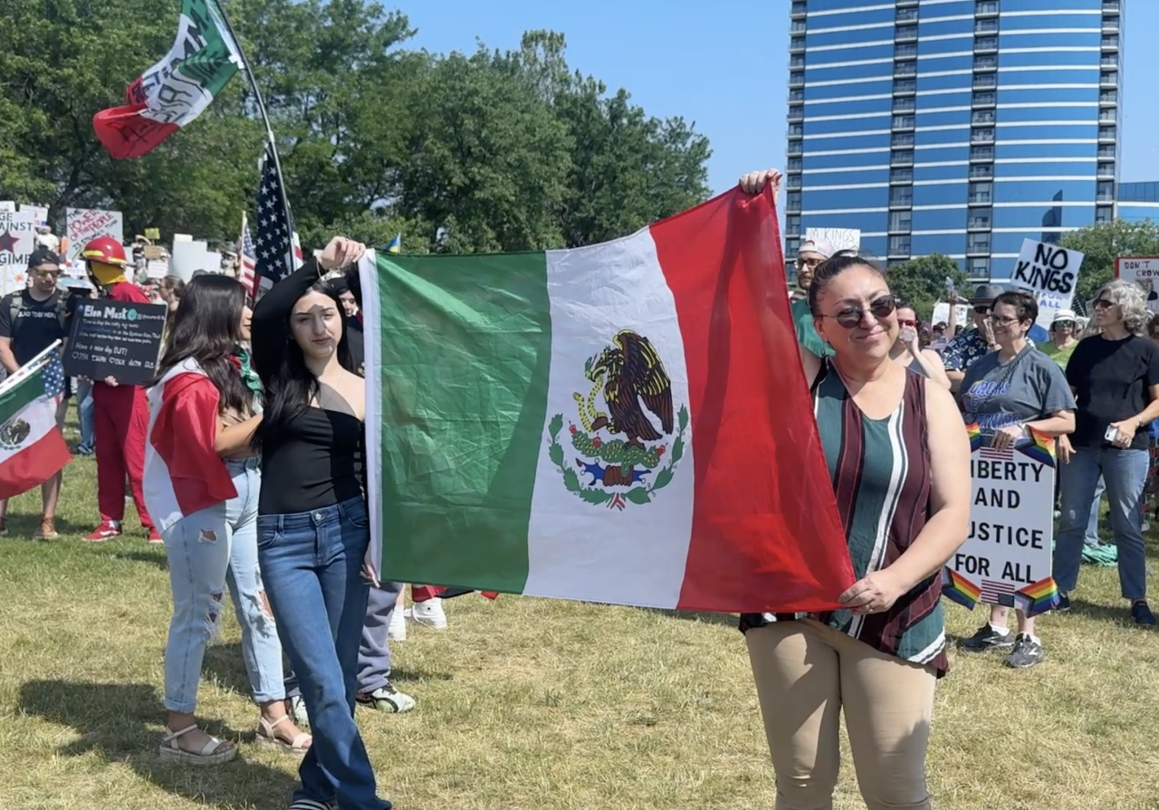 Attendees raising Mexican flag