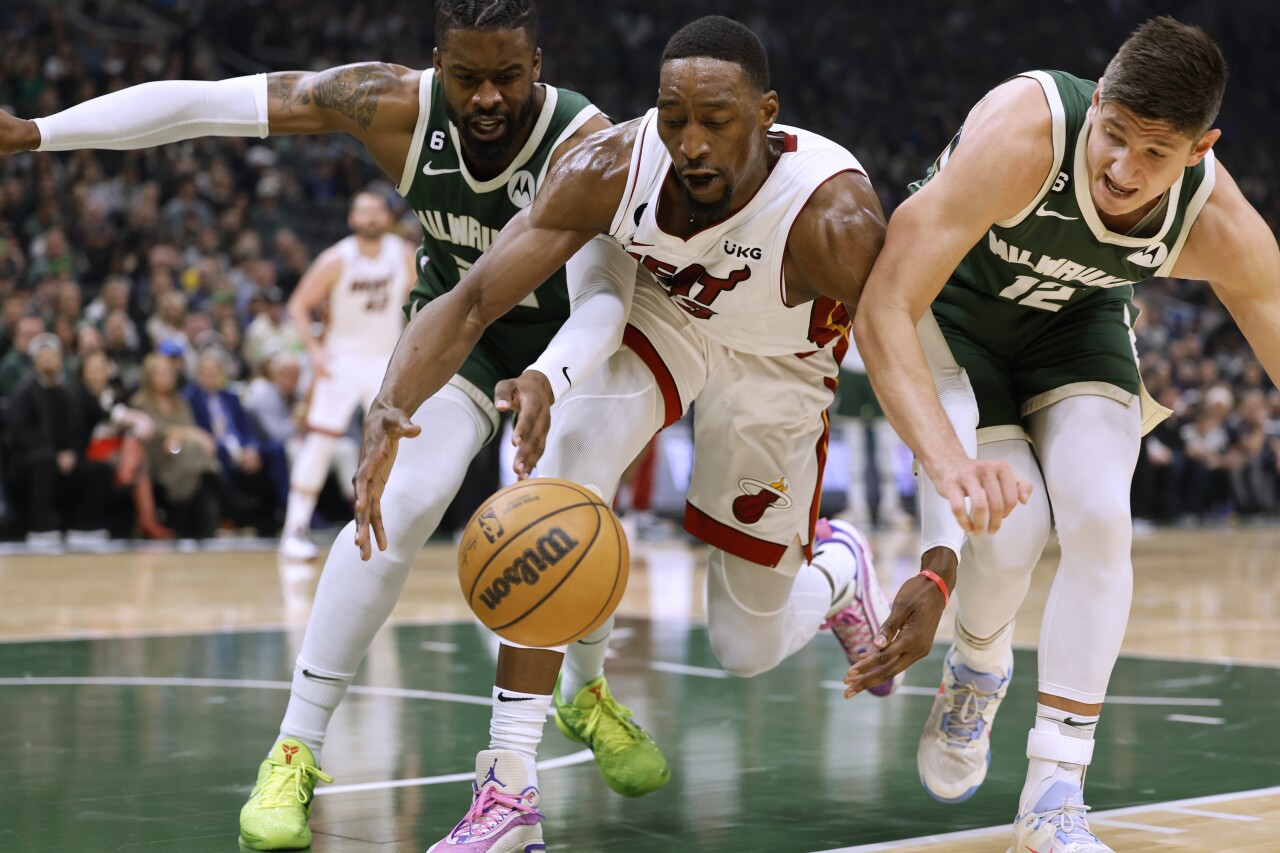 Miami Heat center Bam Adebayo scrambles for ball at Milwaukee Bucks in first half of Game 5 of NBA first-round playoff series, April 26, 2023