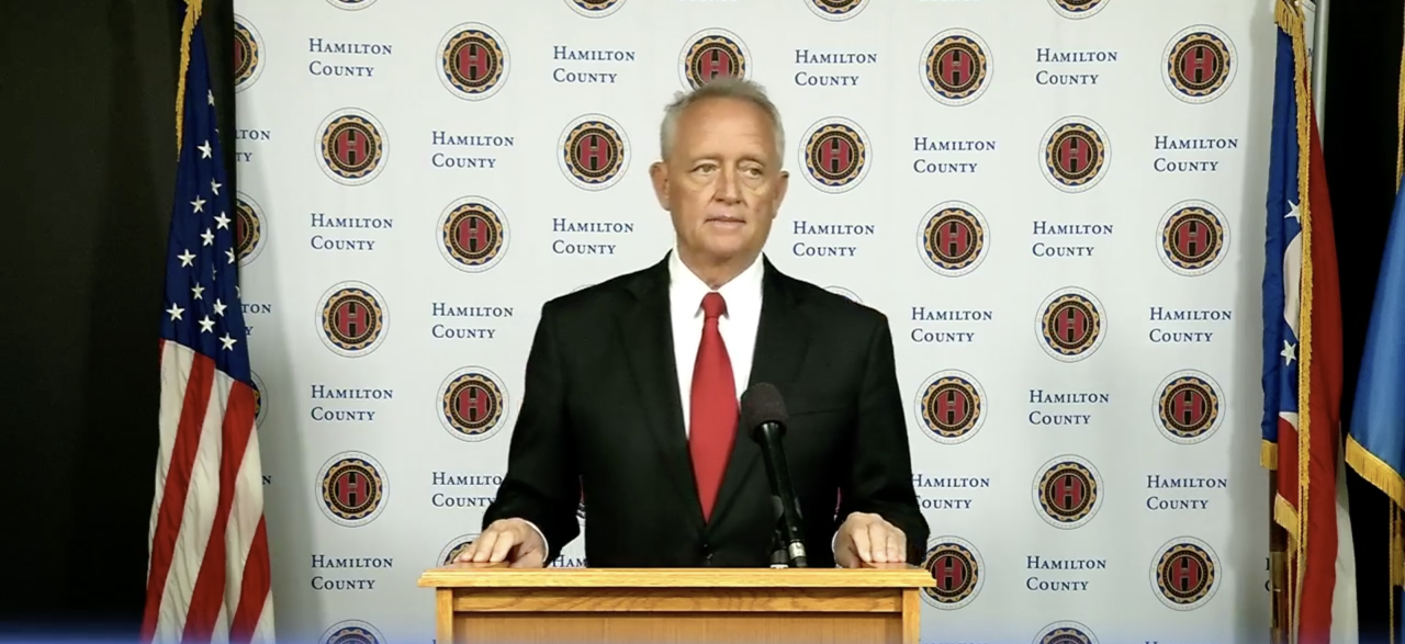 Hamilton County Prosecutor Joe Deters stands at a microphone during a news conference.