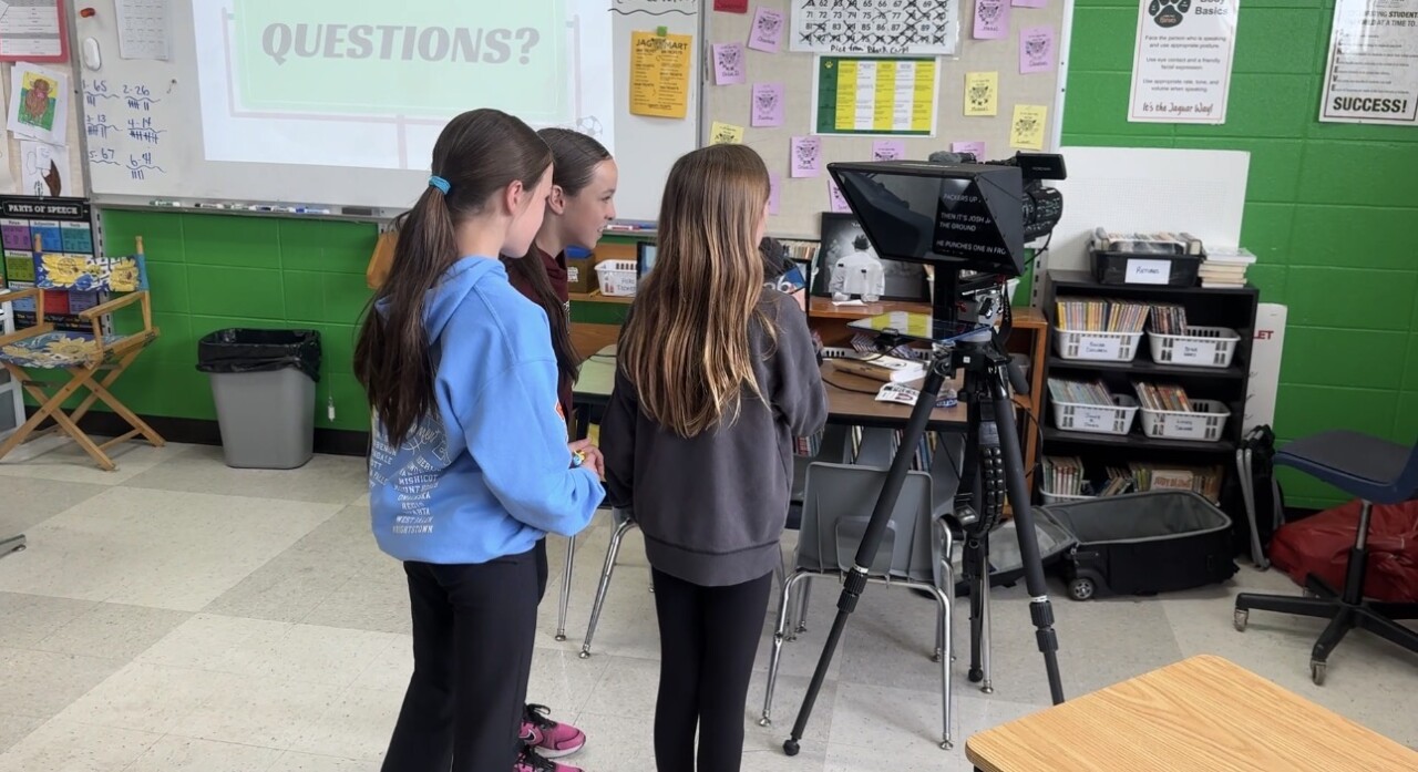 Students read on the teleprompter
