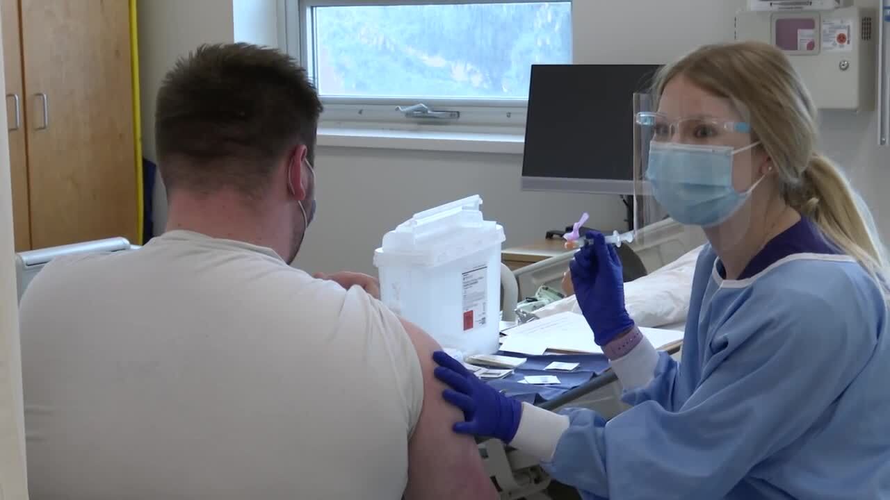 Carroll College nursing student providing COVID-19 vaccine