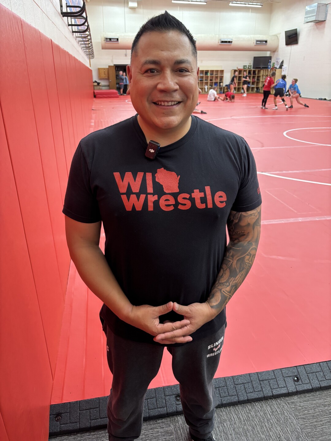 Carlo Davila is the head coach of the Slinger High School girls wrestling team