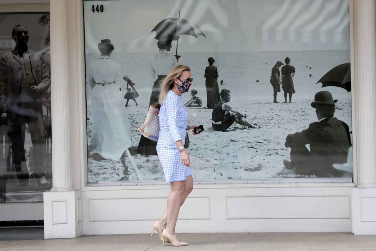 Woman wears mask while walking in Palm Beach