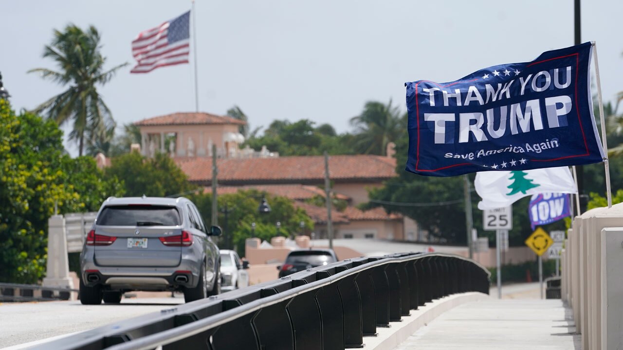 A flag flies in the air near former President Donald Trump's Mar-a-Lago estate, Tuesday, Aug. 9, 2022, in Palm Beach, Fla. 