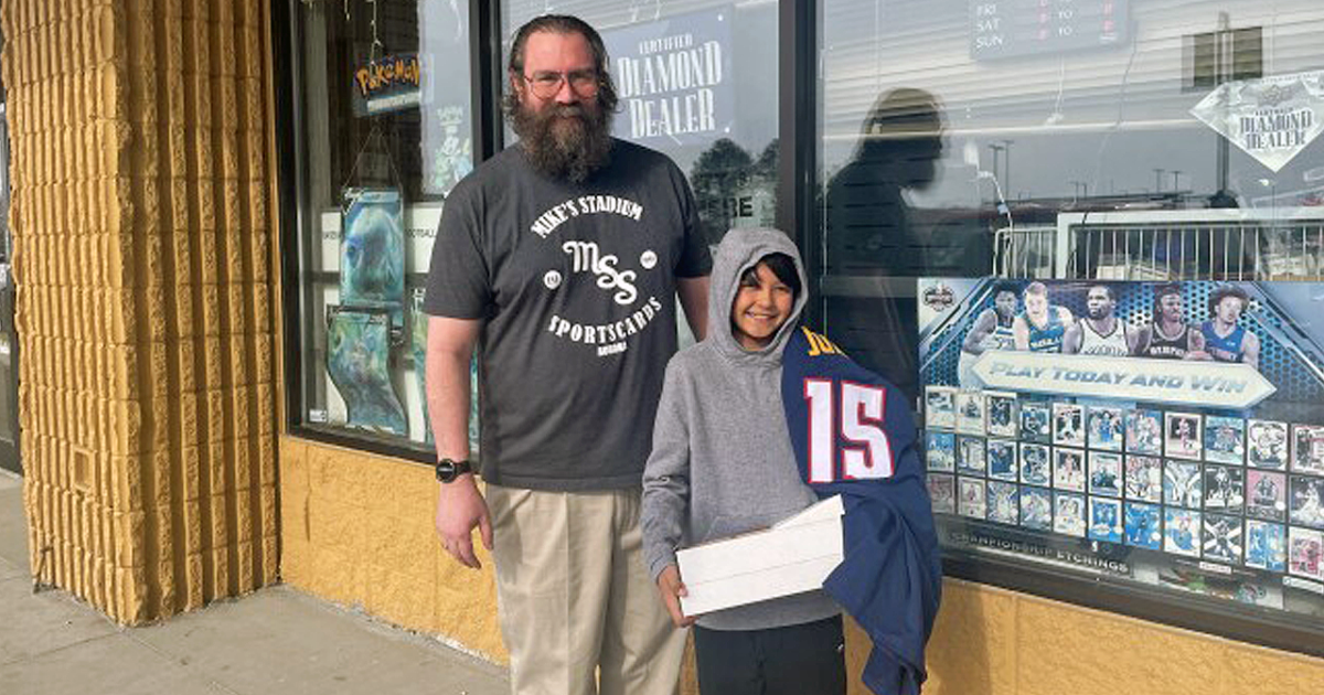 Sports card store owner surprises boy who lost card collection in house fire