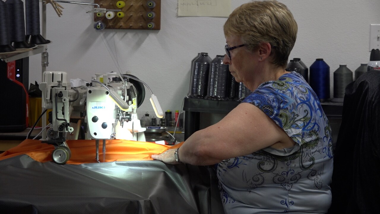 Sandy Paz sews together a seem