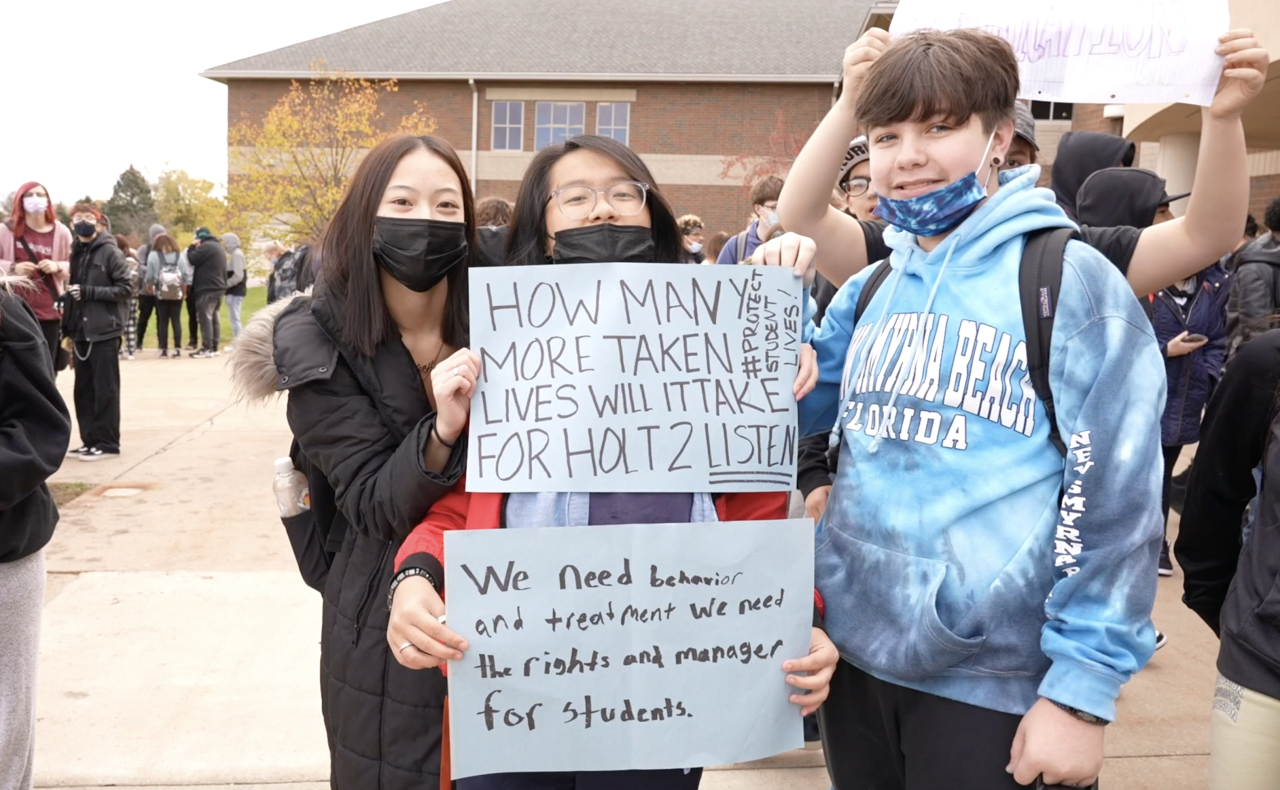 Holt High School students holding signs, demanding change.