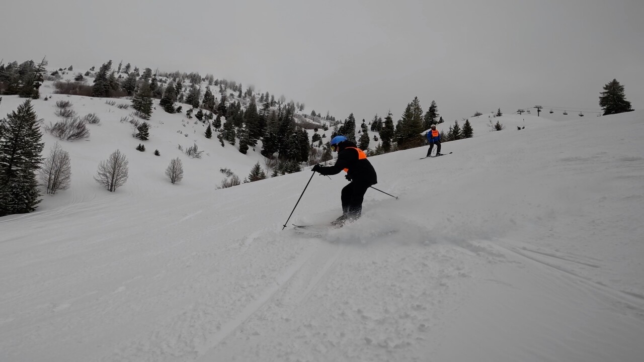Amy Dixon makes a turn as her guide behind her provides instruction