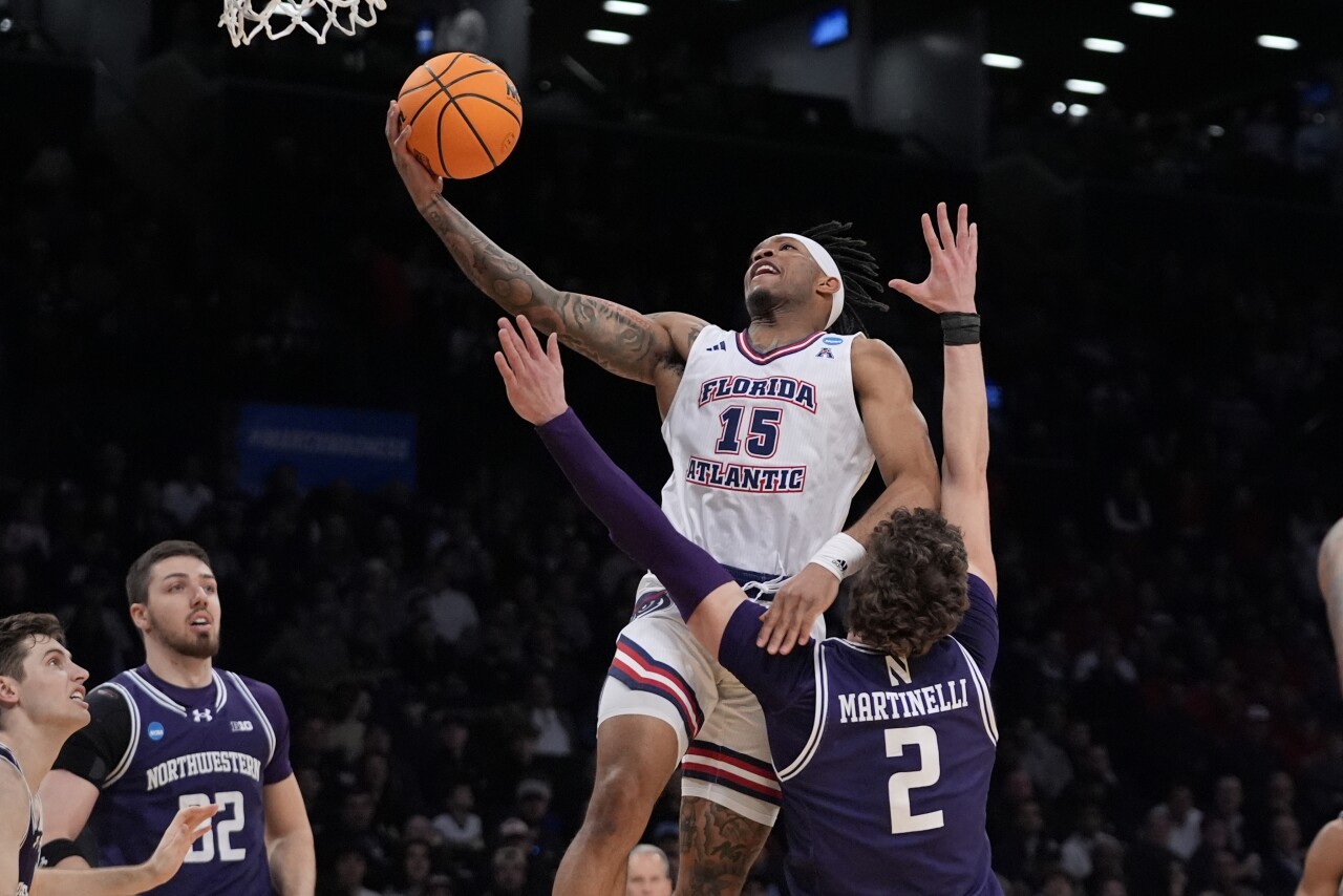 Florida Atlantic Owls guard Alijah Martin drives past Northwestern Wildcats forward Nick Martinelli in NCAA tournament, March 22, 2024