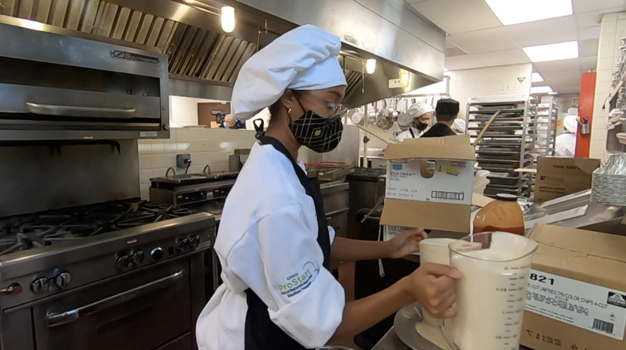 Nyla Minah working inside the Normandy High School kitchen