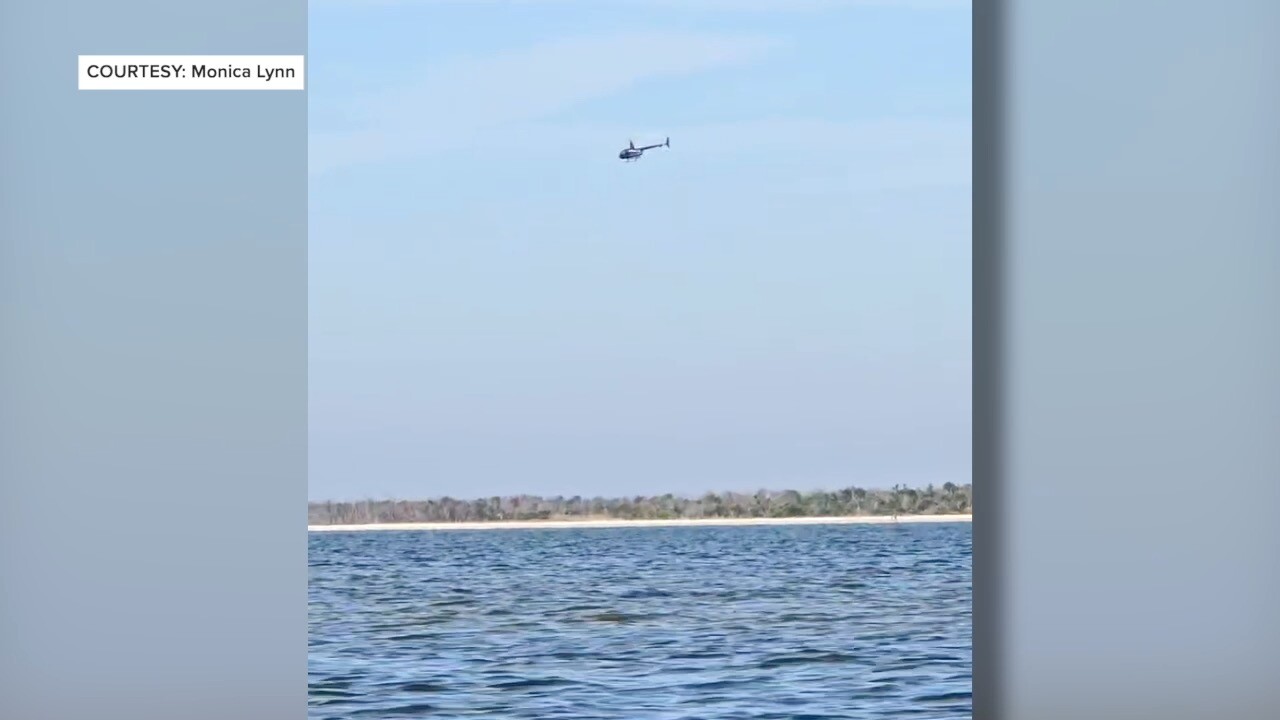 Helicopter flying near Bowditch Point