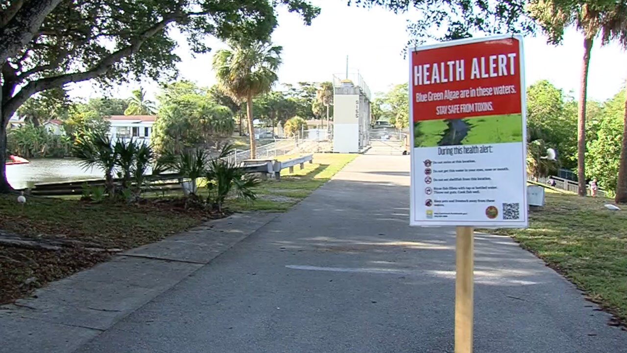 Health alert sign at the C-51 canal at S-155 spillway on June 7, 2021