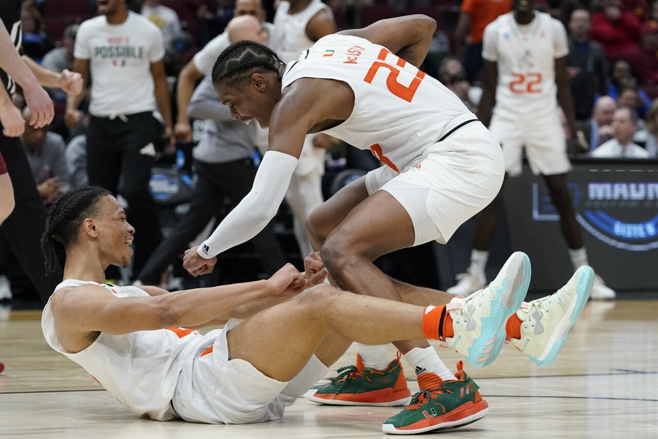 Miami Hurricanes guard Isaiah Wong congratulated by guard Kameron McGusty after making shot and being fouled in 2022 NCAA tournament vs. Iowa State Cyclones
