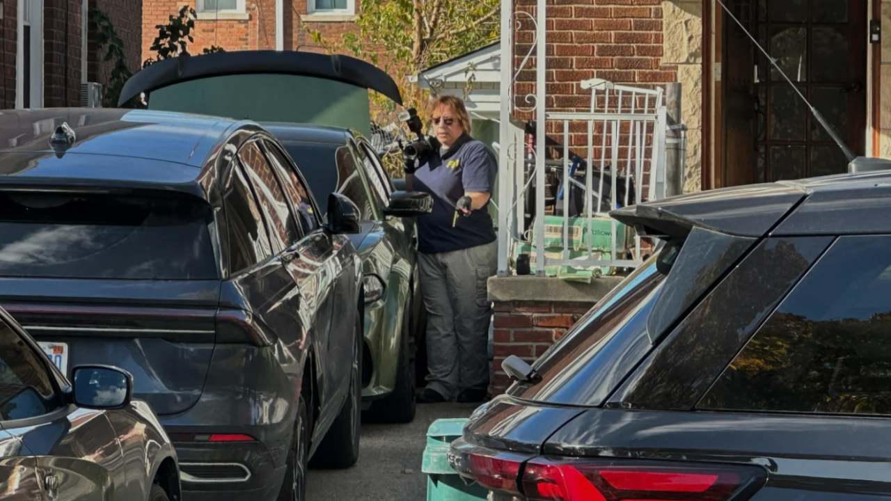 FBI agents gather outside a home in a Dearborn, Mich., neighborhood on Friday, Oct. 31, 2025. 
